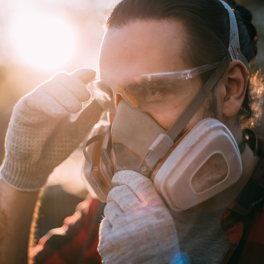 Worker wearing safety mask and gloves.