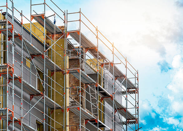 Scaffolding on building for insulation installation.